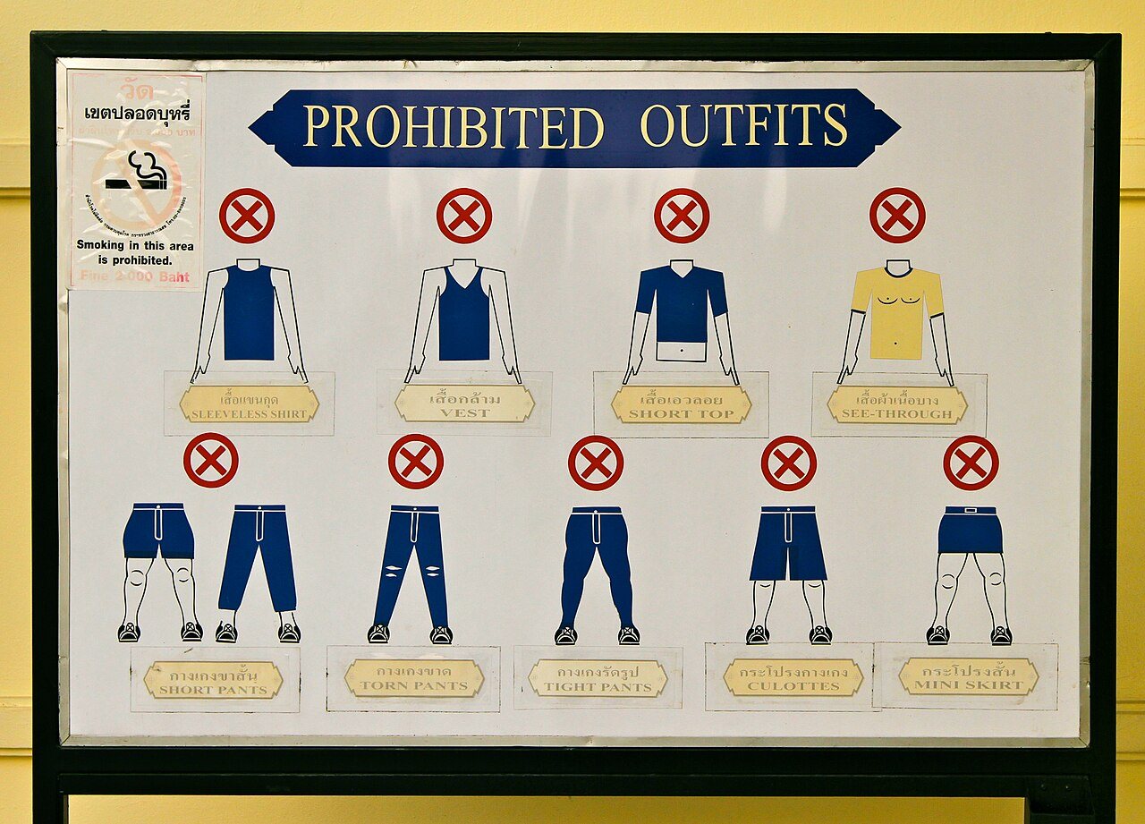 Prohibited outfits dress-code board at the Grand Palace in Bangkok with Thai and English clothing vocabulary