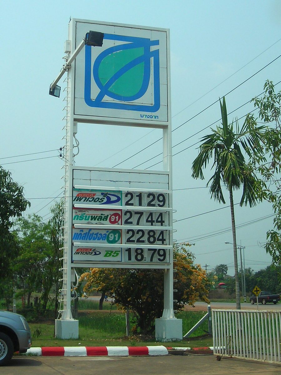 Bangchak petrol station price board in Thailand showing fuel grades written in Thai script with prices per litre
