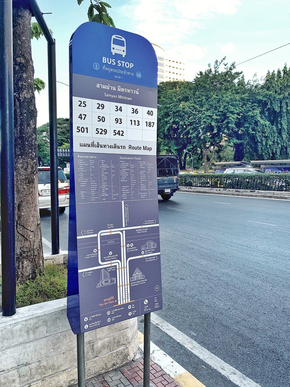Thai bus stop sign at Samyan Mitrtown Bangkok showing khon ha plai thang destination finder and route map in Thai script with transliteration